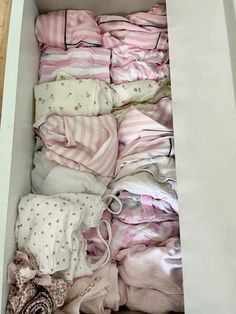 a drawer filled with lots of pink and white clothes