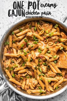 one pot creamy cajun chicken pasta in a skillet with the title above it