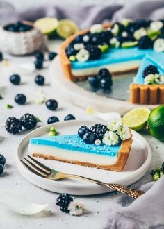 a slice of blueberry cheesecake on a plate with a fork next to it