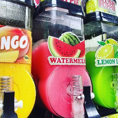 several different flavored sodas and watermelon juice on display in a store