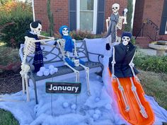 three skeletons sitting on a bench in front of a house with an orange sled