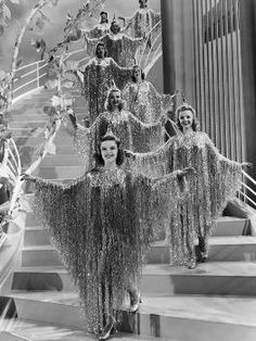 an old black and white photo of women dressed in costumes on the set of showgirls