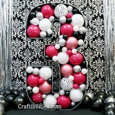 the letter b is made up of balloons and black, white, and red balls