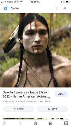 an image of a native american man with white paint on his face and eyebrows, looking at the camera