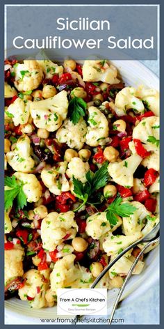 Sicilian Cauliflower Salad in white serving bowl with utensils garnished with fresh parsley.