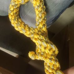 a yellow rope is being held by someone's hand