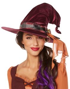 a woman wearing a purple witch hat