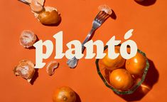 an orange with the word planto written on it next to some fruit and a fork