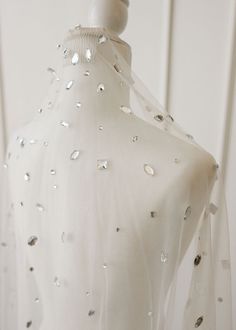 a white dress with silver sequins on it