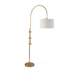 a gold floor lamp with a white shade on the base and a round light fixture