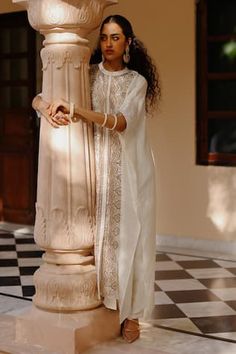 White silk kaftan with hand cut gota embroidery in geometric pattern. Paired with a pant.
Components: 2
Pattern: Embroidery
Type Of Work: Gota
Neckline: Round Collar
Sleeve Type: Three Quarter Sleeves
Fabric: Silk
Color: White
Other Details: 
Closure: Pant: Elastic
Occasion: Mehendi and Haldi - Aza Fashions Gota Embroidery, Pant Women, Pant For Women, Silk Kaftan, Pattern Embroidery, Silk Embroidery, Fashion App, Fabric Silk, White Silk