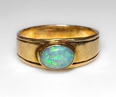 Mid Century c1960s Very nice, low profile 14k band featuring a 1 ct bezel set Australian Precious Opal. Nice fire and flash. Very pretty ring. 4g 14k solid yellow gold Hallmarked Australian Precious Opal 1ct+ S 5.25 US Fine vintage condition Formal 14k Gold Opal Ring With Bezel Setting, Classic Yellow Gold Opal Ring With Bezel Setting, Australian Opal Ring, Ring Inspiration, Pinterest Wedding, Opal Engagement Ring, Opal Band, Pretty Ring, Precious Opal