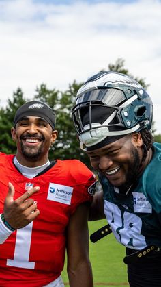 two football players are posing for a photo