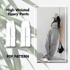 a woman wearing high waisted flowy pants is standing in front of a wall