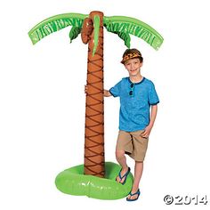 a boy standing next to a palm tree with the words happy new year on it