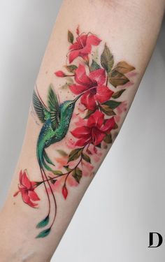 a humming bird with red flowers on its arm