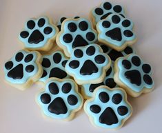 some cookies with black and blue icing are on a table