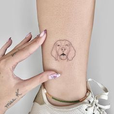 a woman's foot with a dog tattoo on it