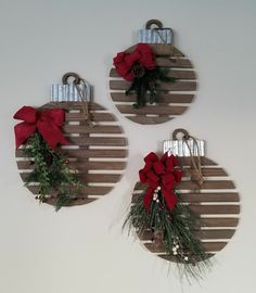 three wooden christmas ornaments hanging on the wall