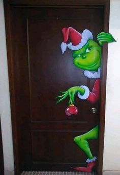 the grinch door is decorated with christmas decorations