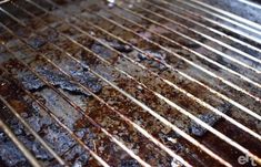 the grill is dirty and rusty with some food on it