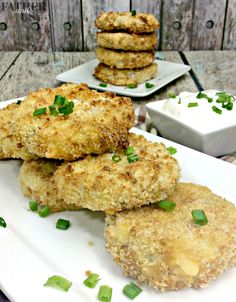 some fried food on a white plate with green garnishes next to it