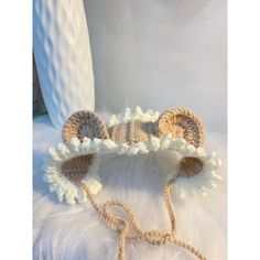 a crocheted headband with white flowers on it and a cord in the middle