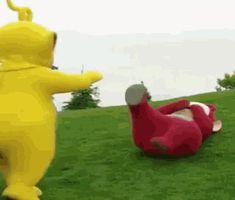 two cartoon figures are in the grass with one laying on its back and another standing up