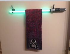 a star wars towel hanging on the wall next to a light up toothbrush holder