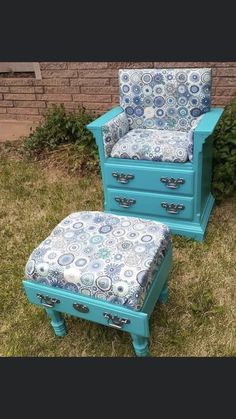 a blue chair and foot stool sitting in the grass