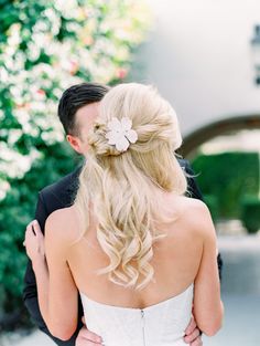 the bride and groom are embracing each other