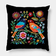 two birds sitting on top of a black pillow with colorful flowers and leaves around them