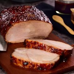 sliced pork on cutting board with knife and fork