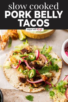 two pork belly tacos on tortillas with radishes and cilantro