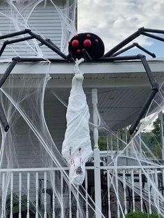 a large spider hanging from the side of a house