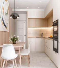 the kitchen is clean and ready to be used for dinner or breakfast time, with white chairs