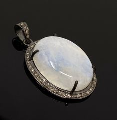 Rainbow Moonstone Gemstone Pave Diamond Oxidized Sterling Silver Exclusive Pendant at Wholesale Price. ** HANDMADE PENDANT** SIZE : 37.75mm x 22.25mm x 9.5mm ( including Bail)( LxWxH) GROSS WEIGHT : 9.06g STONE WEIGHT : 5.16g DIAMOND WEIGHT : 0.39Cts GEMSTONE GRADE : AAA+ GRADE GEMSTONE : NATURAL SMOOTH RAINBOW MOONSTONE TREATMENT : NO TREATMENT METAL : OXIDIZED 925 STERLING SILVER SHAPE : OVAL DIAMOND : GENUINE DIAMONDS SETTING : PAVE SETTING **All Measurements are close approximations** RAINBO San Ramon, Pendant Diamond, Diamond Settings, Moonstone Pendant, Bezel Diamond, Oxidized Sterling Silver, Handmade Pendant, Oval Diamond, Handmade Pendants