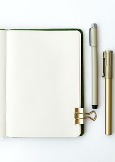 an open notebook with a pen next to it