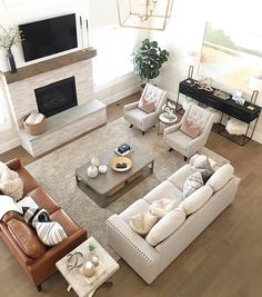 a living room filled with furniture and a flat screen tv mounted on the wall over a fireplace