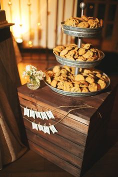 three tiered trays filled with cookies on top of a wooden table