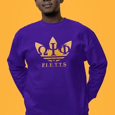 Once you're initiated into the greatest fraternity on earth, you're da bruhz forever! For the sons of blood and thunder, this Omega Psi Phi shirt has a royal purple body with gold sleeves and neckline. Available in sizes S-3XL. 55% cotton 45% polyester polyblend material that is soft and cool to the touch. Features:                                                                                                         -Taped shoulder-to-shoulder -Double-needle stitching throughout -Classic Fit -100% Cotton Purple Crew Neck Top For College, Purple Crew Neck Top With Team Name, Purple Crew Neck Fan Gear Top, Purple Crew Neck Top For Fan Gear, Purple Crew Top For Streetwear, Purple Crew Neck Top For Streetwear, Daughter Style, Omega Psi Phi, Royal Purple