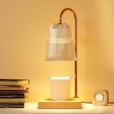 a lamp sitting on top of a table next to books