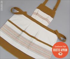 an apron made out of white and brown material with stripes on the front, two straps at the back