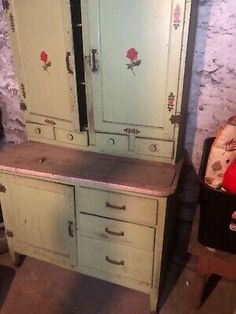 an old dresser and chair in a room