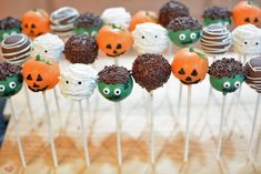 there are many cake pops with faces on them in the shape of pumpkins and jack - o'- lanterns