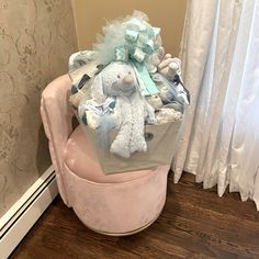 a stuffed animal sitting on top of a pink chair