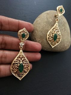 "These are lovely dangling chandelier style earrings in gold .an vintage style gold  teardrop dangle earrings  These are an Indian earrings that could be worn by both traditional and an western attire. This Unique jewellery is designed and crafted at Abi CreatioNzs Abi CreatioNzs is the place for anyone who Is in lookout for a latest trend with an ethnic touch.  We at Abi CreatioNzs offers a great range of Indian Ethnic jewellery's. We are strongly committed to  providing our customers  some uniquely handcrafted products with utmost satisfaction.  Note: The product shipped will be same as shown in the picture however, actual colours may vary slightly from those shown due to lighting in the photography Pls note The shades of gold / silver  may vary slightly. We do not accept any returns or Festive Teardrop Danglers, Pierced, Festive Teardrop Danglers With Pierced Detail, Bollywood Chandelier Drop Earrings With Intricate Design, Ornate Drop Earrings With Latkans, Bollywood Style Chandelier Drop Earrings With Intricate Design, Bollywood Style Chandelier Drop Earrings, Gold Teardrop Bridal Earrings With Intricate Design, Ornate Latkans Drop Danglers, Teardrop Bridal Earrings With Intricate Design