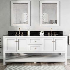 two mirrors are above the double sink vanity in this white bathroom with black countertop