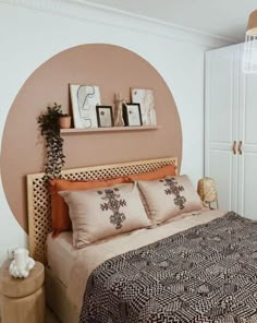 a bedroom with a bed, nightstands and pictures on the wall above it's headboard