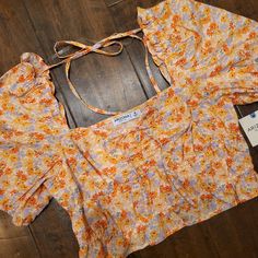 Nwt Arizona Jeans Co. Floral Sunched Ruffley Top With Puffy Like Sleeve. Has Front Tie Detail And One On The Back To Keep The Sleeves Higher If You Want. Reg $36. Measures 7 3/4" Back Middle Top To Bottom, 10" At The Highest Part On The Front To The Bottom, 15 1/2" Pit To Pit. Yellow Puff Sleeve Top With Ruffles, Fitted Ruffle Hem Crop Top For Summer, Cute Yellow Fitted Blouse, Cute Yellow Spring Blouse, Floral Print Crop Top For Spring Brunch, Spring Vacation Crop Top With Ruffles, Summer Crop Top With Ruffles And Short Sleeves, Spring Crop Top With Ruffles, Casual Spring Crop Top With Ruffle Hem